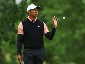 Tiger Woods of the United States catches a ball on the first green during the third round of the 2022 PGA Championship at Southern Hills Country Club on May 21, 2022 in Tulsa, Oklahoma.