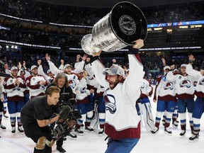 Andrew Cogliano of the Colorado Avalanche hoists the Stanley Cup after his team defeated the Tampa Bay Lightning 2-1 in Game 6 to win the Stanley Cup on Sunday night in Tampa, Fla.