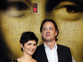 French actress Audrey Tautou (L) and US actor Tom Hanks pose upon arriving at the Cannes train station, southern France, 16 May 2006, on the eve of the start of the 59th edition of the Cannes Film Festival. (Photo credit should read VALERY HACHE/AFP via Getty Images)