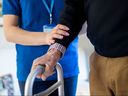 A senior is assisted by a personal support worker.