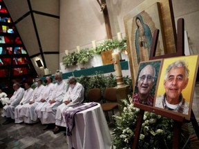 Jesuit priests hold a mass next to the photos of two priests Javier Campos and Joaquin Mora who were murdered in a violent stretch of northern Mexico, at San Ignacio de Loyola church in Mexico City, Tuesday, June 21, 2022.