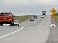 Cars and trucks drive over the "Cavanagh bump" on Highway 7 west of Ottawa.