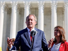 Texas Attorney General Ken Paxton speaks to anti-abortion supporters outside the U.S. Supreme Court following arguments over a challenge to a Texas law that bans abortion after six weeks in Washington, Nov. 1, 2021.
