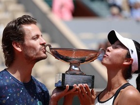 Japan's Ena Shibahara (R) and Netherlands' Wesley Koolhof celebrate with their trophy after winning their mix doubles final match against Norway's Ulrikke Eikeri and Belgium's Joran Vliegen on day 12 of the Roland-Garros Open tennis tournament at the Court Philippe-Chatrier in Paris on June 2, 2022.