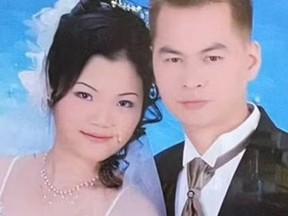 Deliveryman Zhiwen Yan, 45, pictured with his wife Eva Zhao in a wedding photo. He was allegedly murdered over duck sauce.