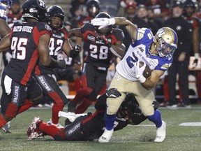 Winnipeg Blue Bombers running back Brady Oliveira is tackled by Ottawa Redblacks defensive back Patrick Levels (3) during the first half at TD Place Stadium on Friday, June 17, 2022.