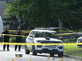 OTTAWA. JUNE 28, 2022 - SIU and police take pictures of evidence on Anoka Street in front of a house, where portable defibrillators and other paramedic equipment is still visible.

Ottawa Police and SIU are investigating an incident at 1273 Anoka Street that resulted in three deaths Monday night. 
At about 10:30 pm, police were called to the scene after reports of multiple stabbings. Two people were found dead, a third with multiple stab wounds, remains in hospital and another individual died after an "interaction" with police at the scene. 
Neighbours said they heard loud screaming for a number of minutes followed by gun shots. 
Julie Oliver/Postmedia