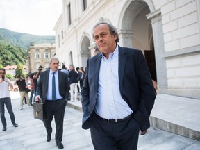 The former president of the the European Football Association (Uefa) Michel Platini, center, is leaving the Swiss Federal Criminal Court in Bellinzona, Switzerland, after the first day of his trial, Wednesday, June 8, 2022.