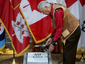 Algonquin Elder Peter Decontie blesses the newly unveiled symbols on Tuesday, June 21, 2022.