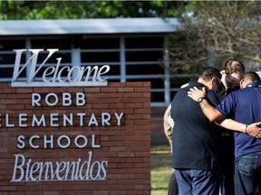 People gather at Robb Elementary School, the scene of a mass shooting in Uvalde, Texas, U.S., May 25, 2022.