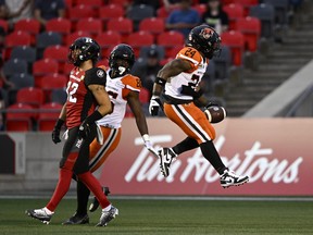 BC Lions running back James Butler (24) skips in the air in celebration after scoring a touchdown during first half CFL football action against the Ottawa Redblacks.