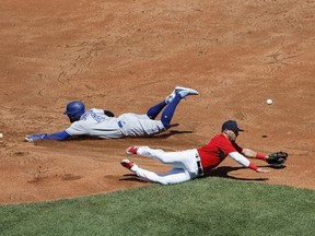 George Springer of the Blue Jays safely steals second base as the throw gets past Yolmer Sanchez of the Red Sox during the second inning at Fenway Park on July 24, 2022 in Boston.