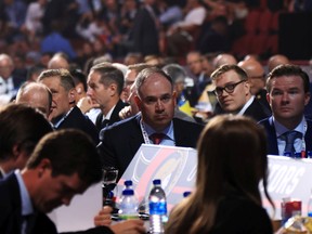 Senators general manager Pierre Dorion, middle, during the first round of the NHL draft in Montreal on Thursday night.