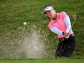 Brooke Henderson plays a shot from a bunker on the 18th hole on day two of The Amundi Evian Championship at Evian Resort Golf Club on July 22, 2022 in Evian-les-Bains, France.