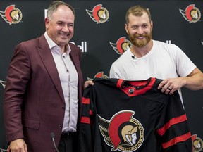 Newest Ottawa Senator Claude Giroux is presented with his team jersey by general manager Pierre Dorion at the Canadian Tire Centre.