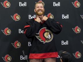 Newest Ottawa Senator Claude Giroux puts on the team jersey, as his 3 year old son Gavin watches, at the Canadian Tire Centre. July 13,2022.