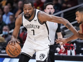 Brooklyn Nets forward Kevin Durant (7) dribbles against Atlanta Hawks guard Timothe Luwawu-Cabarrot (7) during the first half at State Farm Arena Dec 10, 2021.