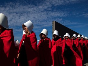 Activists in favour of the legalization of abortion disguised as characters from Canadian author Margaret Atwood's feminist dystopian novel "The Handmaid's Tale." (Photo by ALEJANDRO PAGNI/AFP via Getty Images)