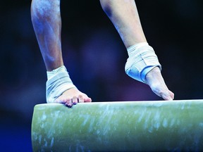 A gymnast on a balance beam.