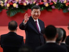 China's President Xi Jinping waves following his speech after a ceremony to inaugurate the city's new leader and government in Hong Kong on Friday, July 1, 2022, the 25th anniversary of the city's handover from Britain to China.