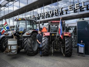 Farmers block the arrival and departure halls at Groningen Airport Eelde in Eelde, the Netherlands, to protest against the Dutch government's far-reaching plans to cut nitrogen emissions on July 6, 2022. - The Netherlands, the world's second-largest agricultural exporter, is one of the top greenhouse gas emitters in Europe -- especially of nitrogen -- with much of this blamed on cattle-produced manure and fertiliser.