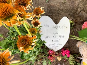 OTTAWA- July 26, 2022 --A tree has a memorial of  flowers and a heart shaped messages to honour the woman hit by a truck on Friday last week on Marier Avenue in Ottawa.