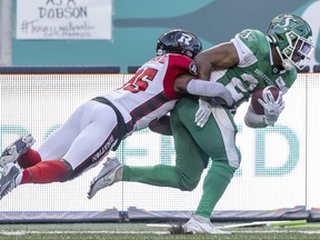 Ottawa Redblacks' Douglas Coleman tackles Saskatchewan Roughriders running back Jamal Morrow (25) at Mosaic Stadium on Friday.