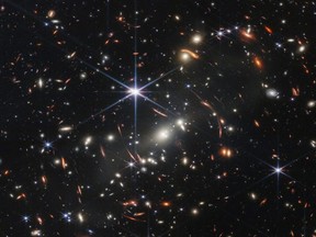 The first full-colour image from NASA's James Webb Space Telescope, a revolutionary apparatus designed to peer through the cosmos to the dawn of the universe, shows the galaxy cluster SMACS 0723, known as Webb?s First Deep Field, in a composite made from images at different wavelengths taken with a Near-Infrared Camera and released July 11, 2022.