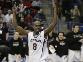 File photo: Game hero Ottawas' #8 Johnny Berhanemeskel  reacts after sinking the winning basket. Ottawa Gee Gees come from behind to beat Carlton Ravens in the OUA Final   in Toronto, Ont. on Saturday March 1, 2014. Craig Robertson/Toronto Sun/QMI Agency