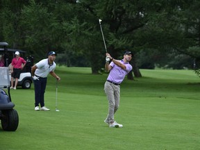 Jaegar Prot (left) and Jesse Riopelle (swinging) at the Sun Scramble's Open Division Tournament Friday at The Hylands. Prot and Riopelle shot a 13-under 59 and will lead the field into Sunday's championship round at The Marshes.