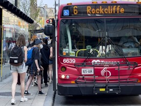 Files: OC Transpo passengers board a bus on Rideau Street.