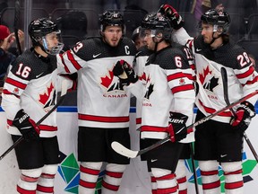 Team Canada's Mason McTavish (23) celebrates a hat trick goal with teammates during second period World Junior Hockey Championship action at Rogers Place in Edmonton on Thursday, Aug. 11, 2022.