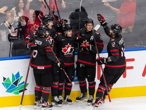 Team Canada's Logan Stankoven (10) celebrates a goal with teammates on Team Switzerland's goaltender Noah Patenaude (29) during first period IIHF World Junior Championship action at Rogers Place in Edmonton, on Wednesday, Aug. 17, 2022. Photo by Ian Kucerak