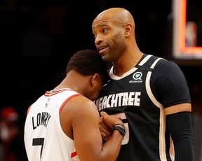 Vince Carter #15 of the Atlanta Hawks and Kyle Lowry #7 of the Toronto Raptors hug after the Raptors 122-117 win at State Farm Arena on January 20, 2020 in Atlanta, Georgia.