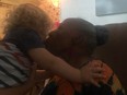 Nina Lipscomb, 82, gets a kiss from 18-month-old son Ethan Moore during a reunion with the toddler who spotted the missing senior while blowing bubbles with his mom in Georgia.