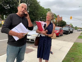 A bailiff named Dave, left, who declined to give his last name, arrives at St. Brigid’s church in Lowertown to serve legal papers on William Komer, a director of The United People of Canada organization, concerning an eviction hearing in an Ottawa court on Sept. 2. The landlord is trying to terminate TUPOC’s lease, which has led to a week-long standoff.