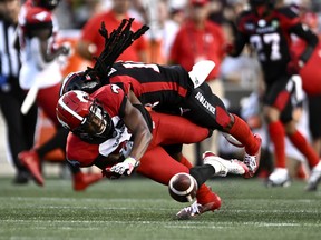 Calgary Stampeders wide receiver Kamar Jorden (88) grimaces as he is tackled by Ottawa Redblacks defensive back Abdul Kanneh (14) during first half CFL football action at Ottawa on Friday, August 5, 2022.