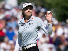 Canadian Brooke Henderson acknowledges the crowd as sinking her putt on the 18th hole during the third round of the CP Women's Open, on at  Ottawa Hunt and Golf Club on Saturday.