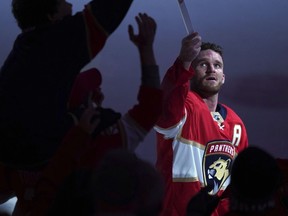 Florida Panthers left wing Jonathan Huberdeau gives his hockey stick to a fan as he is honored as the third star of the game following a win over the Montreal Canadiens NHL hockey team Tuesday, March 29, 2022, in Sunrise, Fla.