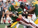Edmonton Elks quarterback Taylor Cornelius (15) protects the ball in the ball in the first half against the Redblacks on Friday night. 
