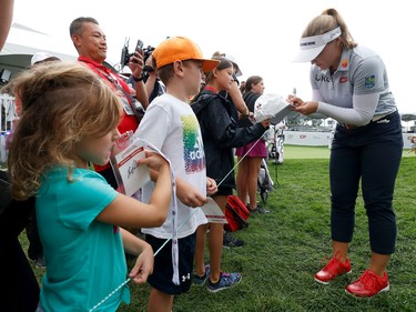Brooke Henderson signs an autograph on Tuesday at the Ottawa Hunt and Golf Club.