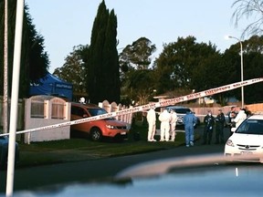 Police outside home in South Auckland, where human remains were found inside suitcases.
