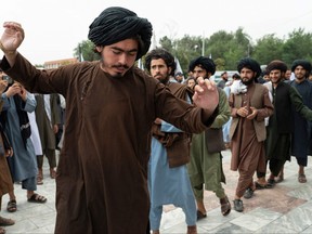 Taliban fighters dance as they celebrate their victory at the Ahmad Shah Massoud Square in Kabul on Aug. 15, 2022.