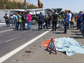 Emergency and rescue teams attend the scene after a bus crash accident on the highway between Gaziantep and Nizip, Turkey, Saturday, Aug. 20, 2022.
