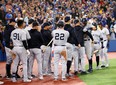 Aaron Judge #99 of the New York Yankees is congratulated by teammates after hitting his 61st home run of the season in the seventh inning against the Toronto Blue Jays at Rogers Centre on September 28, 2022 in Toronto. (Photo by Vaughn Ridley/Getty Images)