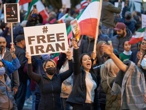 People demonstrate against the Iranian regime during a protest at Mel Lastman Square in Toronto on Sept. 24, 2022. Iran has been rocked by street violence since the death of Mahsa Amini, a 22-year-old Kurd who had spent three days in a coma after being detained by the morality police.