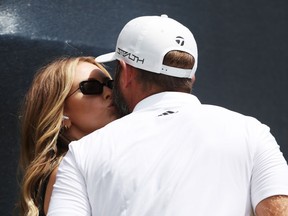 Dustin Johnson of the United States kisses his wife Paulina Gretzky as he walks off the ninth hole during the second round of the 122nd U.S. Open Championship at The Country Club on June 17, 2022 in Brookline, Mass.