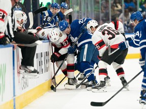 Maple Leafs winger Joey Anderson (28) battles along the boards with Ottawa Senators forward Matthew Wedman during an exhibition doubleheader on Saturday in Toronto.