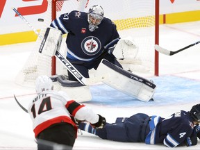 Winnipeg Jets goaltender Connor Hellebuyck stops a shot from Ottawa Senators forward Tyler Motte in NHL exhibition action at Canada Life Centre in Winnipeg last night.