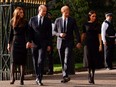 Britain's William, Prince of Wales, Catherine, Princess of Wales, Britain's Prince Harry and Meghan, the Duchess of Sussex, walk outside Windsor Castle, following the passing of Queen Elizabeth, in Windsor, Britain, Saturday, Sept. 10, 2022.